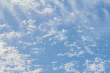 Soft scattered white clouds in the blue sky