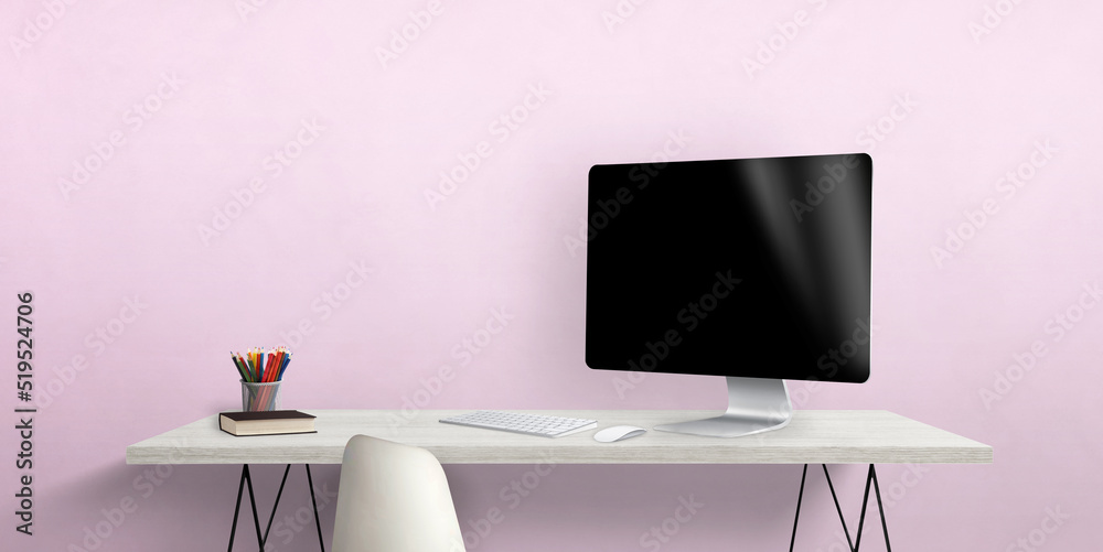 Poster blank computer display on work desk with pens and book beside. pink wall in background