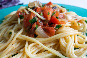 Pasta, spaghetti with tomato sauce, parmesan cheese and basil in plate on white background.