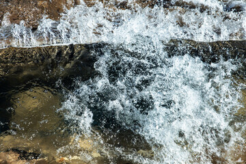 force of the water splashing against the rocks.water splash