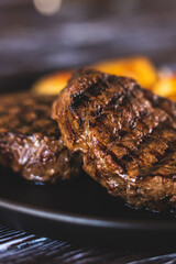 Appetizing steak with potatoes close-up