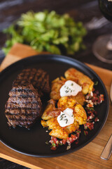 Appetizing steak with potatoes close-up