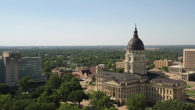 Kansas state capitol building in Topeka, Kansas with wide shot of drone video moving sideways.