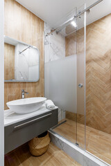 Large mirror over vessel sink in stylish bathroom interior