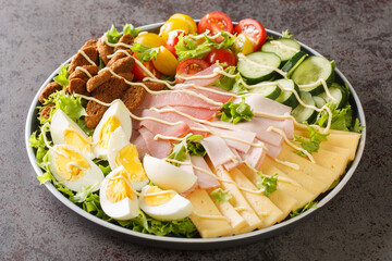 American hearty chef salad of vegetables, lettuce, eggs, cheese, croutons and several types of meat...