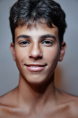 Close-up studio portrait of handsome teenage boy.