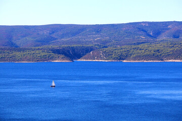 Fototapeta na wymiar Sailing boat and beautiful Adriatic sea landscape in Croatia.