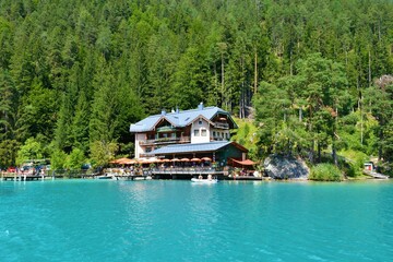 Fototapeta na wymiar Hotel at the shore of Weissensee lake in Carinthia, Austria