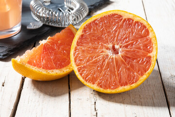 Fresh grapefruit slices on white wooden table