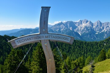 Wooden cross at the top of Techantinger mittagskogel or Trupijevo Poldne mountain with mountain...