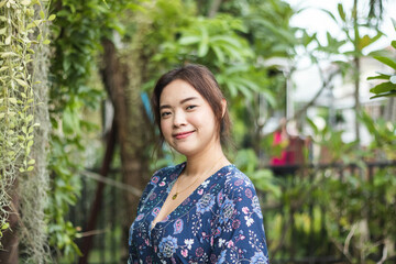 Close up of young pretty Asian woman in the garden.