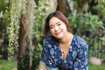 Fototapeta premium Close up of young pretty Asian woman in the garden.