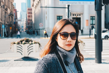 Obraz premium Beautiful young Asian woman in her winter jacket, traveler concept.