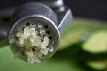 grated squeezed garlic with green cucumber. close-up. macro.