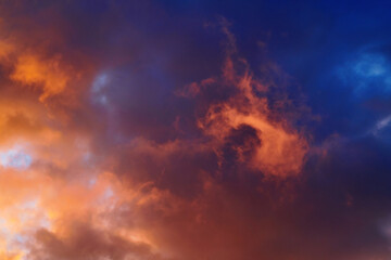 Yellow sunset sky with orange thunder clouds, thunderclouds. Nature sky background. Twilight sky, Colorful sunset sky and clouds. Fiery sunset, sky on fire.
