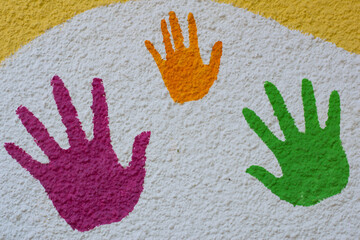 Multicolored handprints on white background. Top view