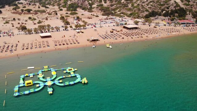 Inflatable Island At Water Park In Tsambika Beach, Greece. - aerial 