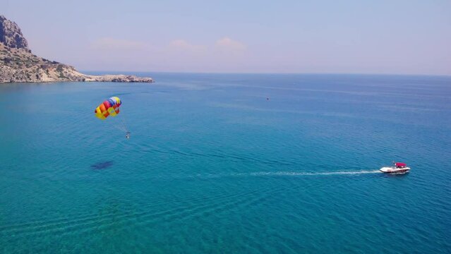 Parasailing Watersports Adventure In Tsambika Beach, Rhodos, Greece. Wide Shot