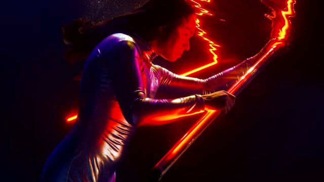 Fantastic Woman Superhero Is Swimming In Dark Water Of Ocean, Holding Red Light Wand In Hands