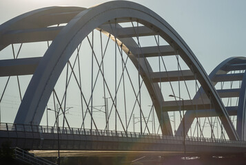 Fototapeta premium Novi Sad, Serbia. July - 25. 2022. Zezelj bridge on river Danube in Novi Sad. View of the Zezelje Bridge on the Danube in Novi Sad from the Petrovaradin side in the summer and in the afternoon.
