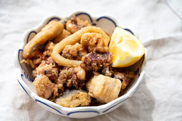 Spanish sea food, cripsy deep fried baby octopus, fish, calamari rings served with lemon