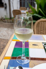 Glass of Spanish dry white wine served on outdoor terrace in Granada, Spain