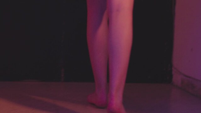 back view of depressed woman who fights sadness by drinking walking staggering