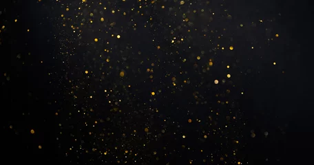 Gold glitter shimmer dust shiny lights particles dark abstract background © nevodka.com