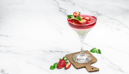 Dessert Panna Cotta with fresh strawberry in glass with strawberries. Italian dessert on a light background. Restaurant menu, dieting, cookbook recipe top view