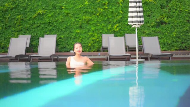 Young Sexy Exotic Woman Enjoying in Swimming Pool Water of Luxury Caribbean Resort