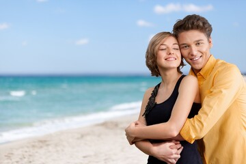 Happy satisfied smiling young couple family man woman hug rest together at sunrise over sea beach ocean outdoor seaside in summer day