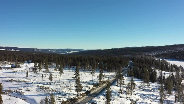 Nesfjellet mountain during winter - Clear sunny day ascending aerial revealing panoramic view above Norway highlands towards Rukkedalen and Nesbyen