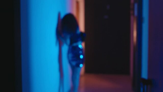 frightened woman runs down the corridor to escape from her assailant