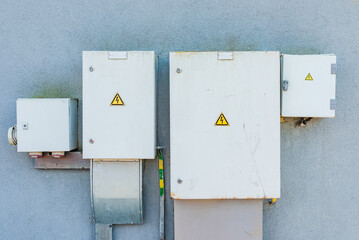 The aged old Grey Hinged Power electrical Boxes on the Wall.