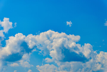 Fototapeta na wymiar White fluffy clouds in the blue sky summer background.Cloudy white blue sky in the nice blue heaven sky.