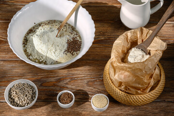 Ingredients for baking and creamer on dark wooden table