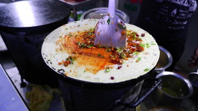 Mixing Herbs and masala or spices on Dosa
