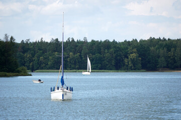 Sailboat swimming with en engine - front view