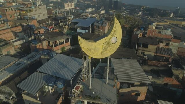 Aerial approaching golden moon structure on the top of Providencia favela in central Rio de Janeiro, Brazil
