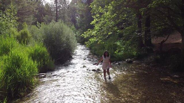 Sport group of people hiking through river Tus in Cazorla, Spain. Sport walking amidst nature in forest.