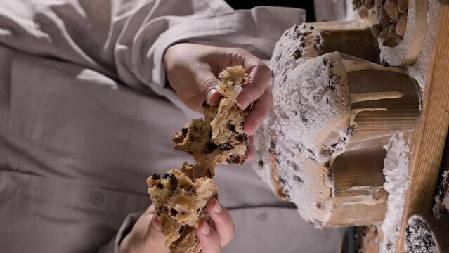 Easter dove in female hands . Colomba di Pasqua - traditional italian easter dove cake with glaze macaranage, almonds. Easter dove on a board. High quality 4k footage