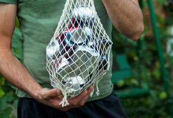 Drink cans crumpled and folded into a rag net for disposal