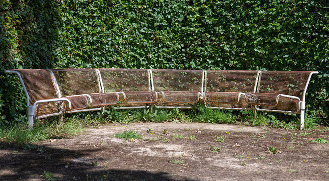 Rusty Metal Benches In A Circle Without People In A Park. There Are No Trademarks In The Shot.