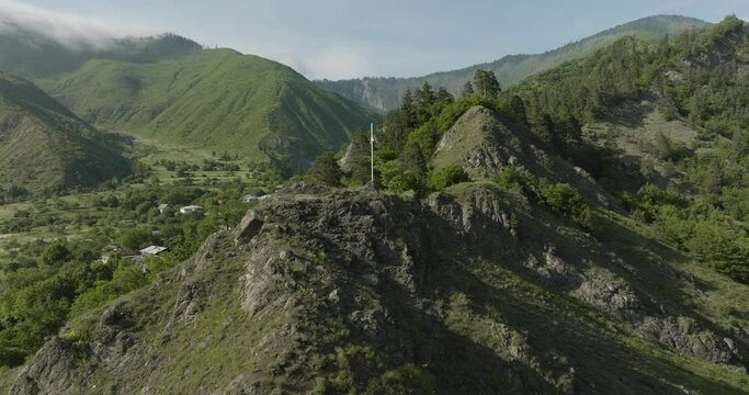 Cross On The Summit Of Rocky Mountain In Daba, Georgia. - aerial orbit