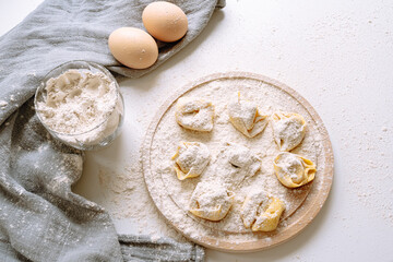 Making tortellini home, handmade, on kitchen worktop