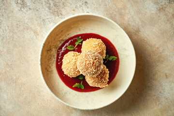 Croquette with cheese in cranberry sauce. Close-up selective focus