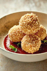 Croquette with cheese in cranberry sauce. Close-up selective focus