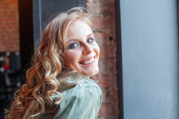 Fototapeta premium Young happy woman laughing indoor