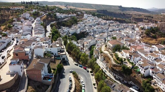 , Spain, April 2022; People walk at Setenil de las Bodegas, a white old ancient town in andalucia mountains, Spain.