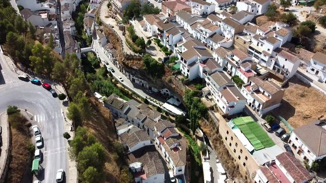 , Spain, April 2022; People walk at Setenil de las Bodegas, a white old ancient town in andalucia mountains, Spain.